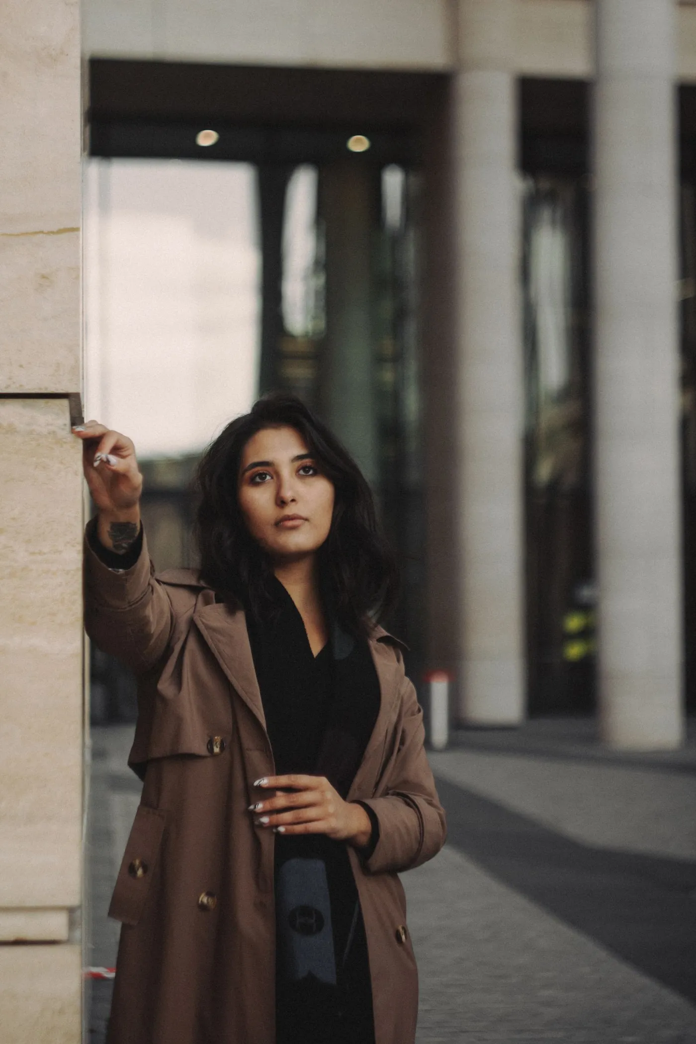 Woman wearing a trench coat outdoors