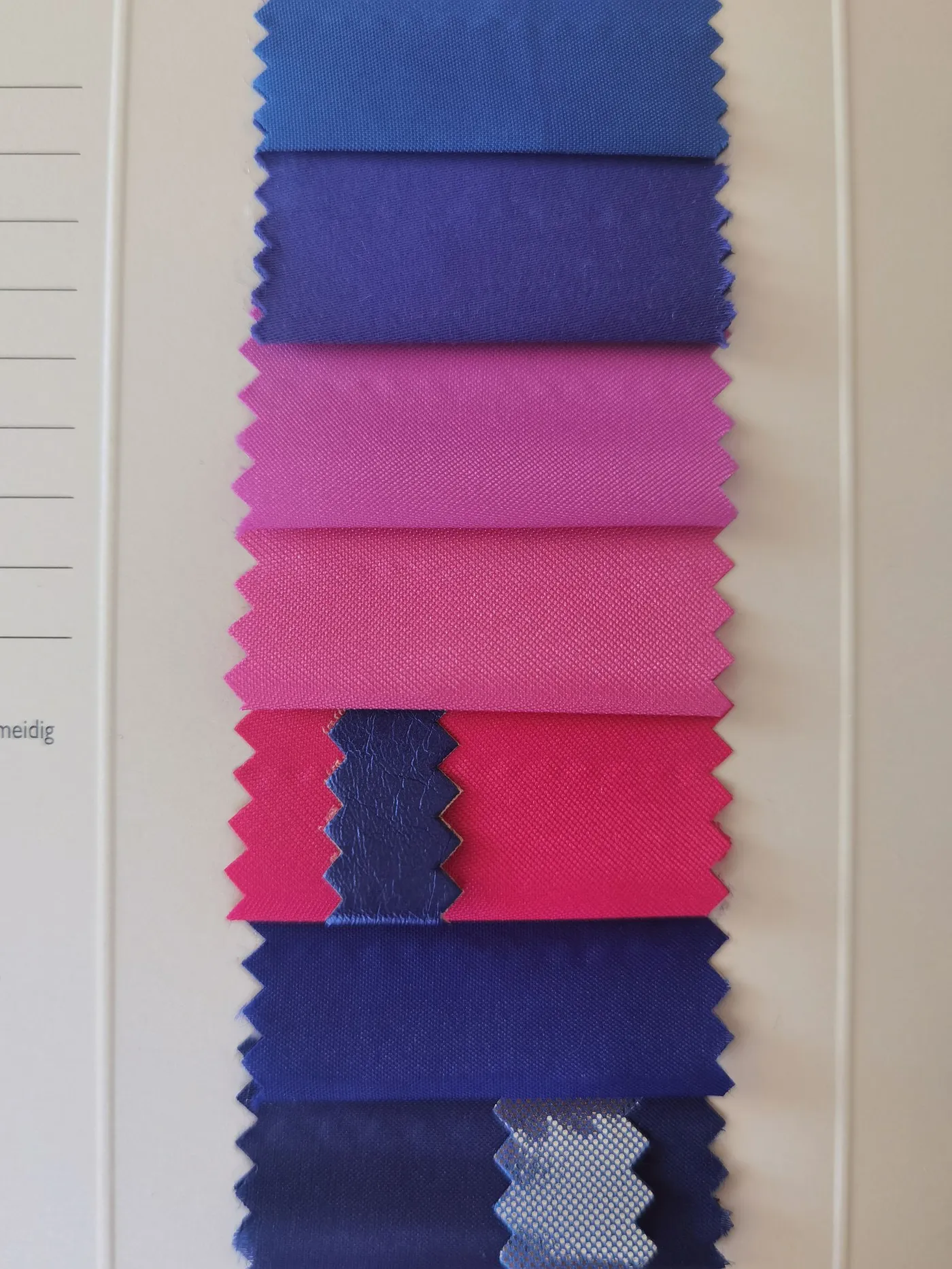 Layered fabric swatches in blue, pink and neutral shades