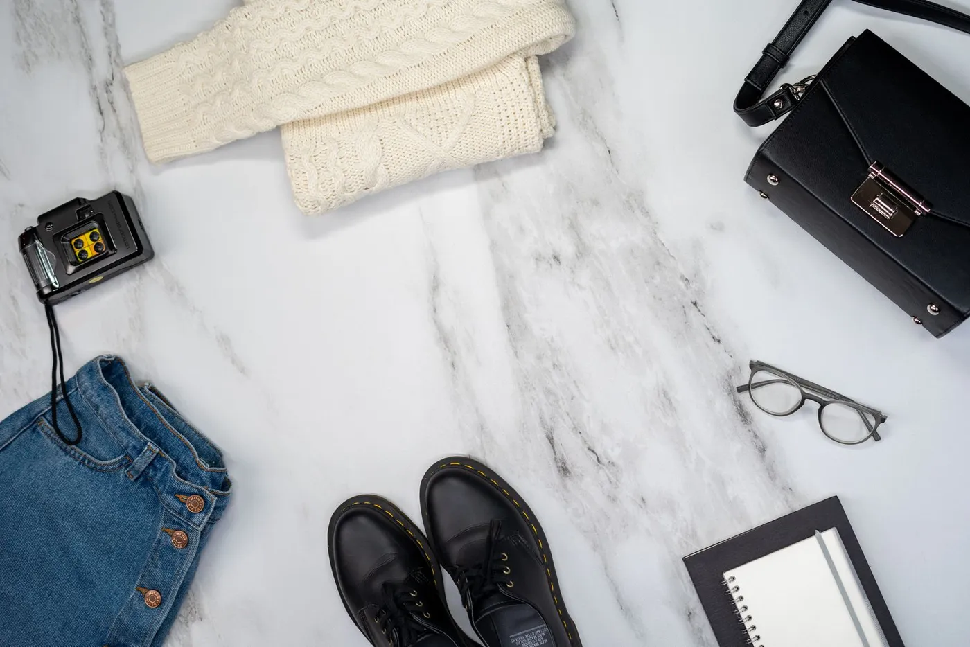 Casual clothing and accessories laid out together