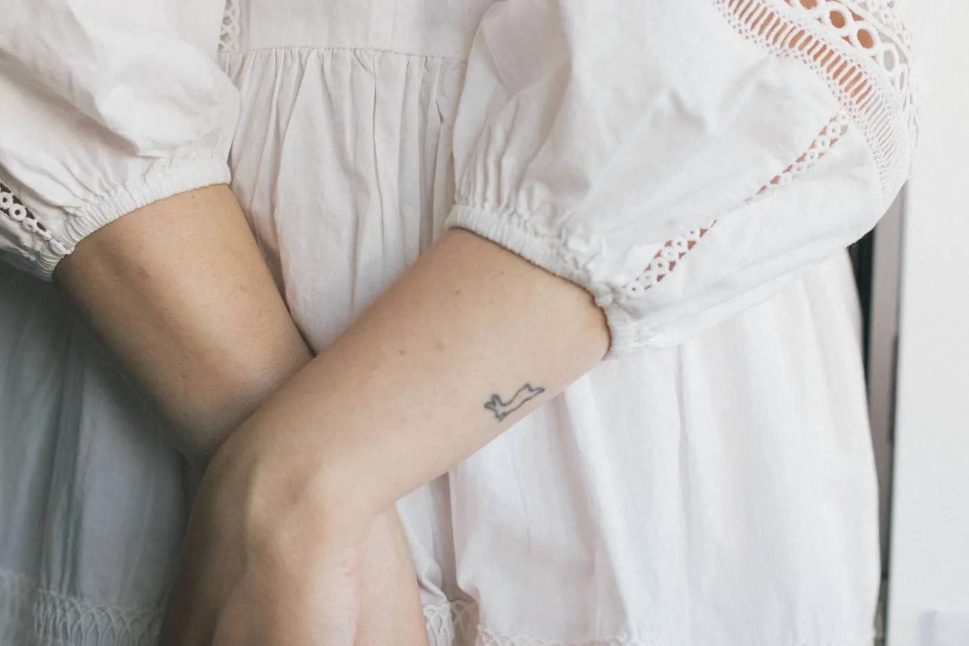 Detail of a white embroidered linen dress