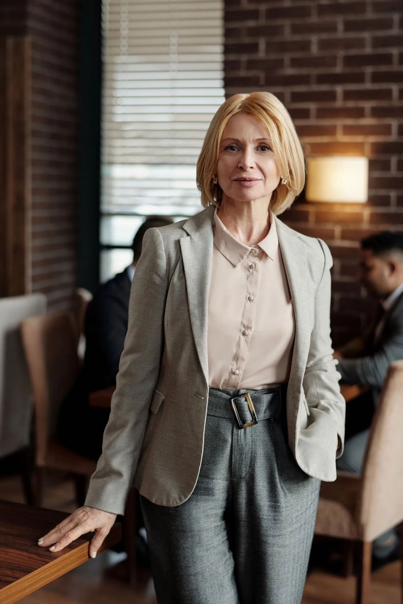 Woman wearing a tailored blazer and trousers indoors