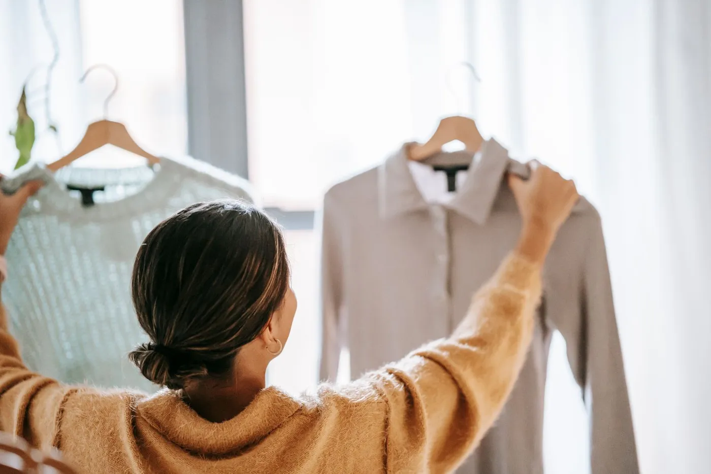 Woman comparing garments while shopping for clothes