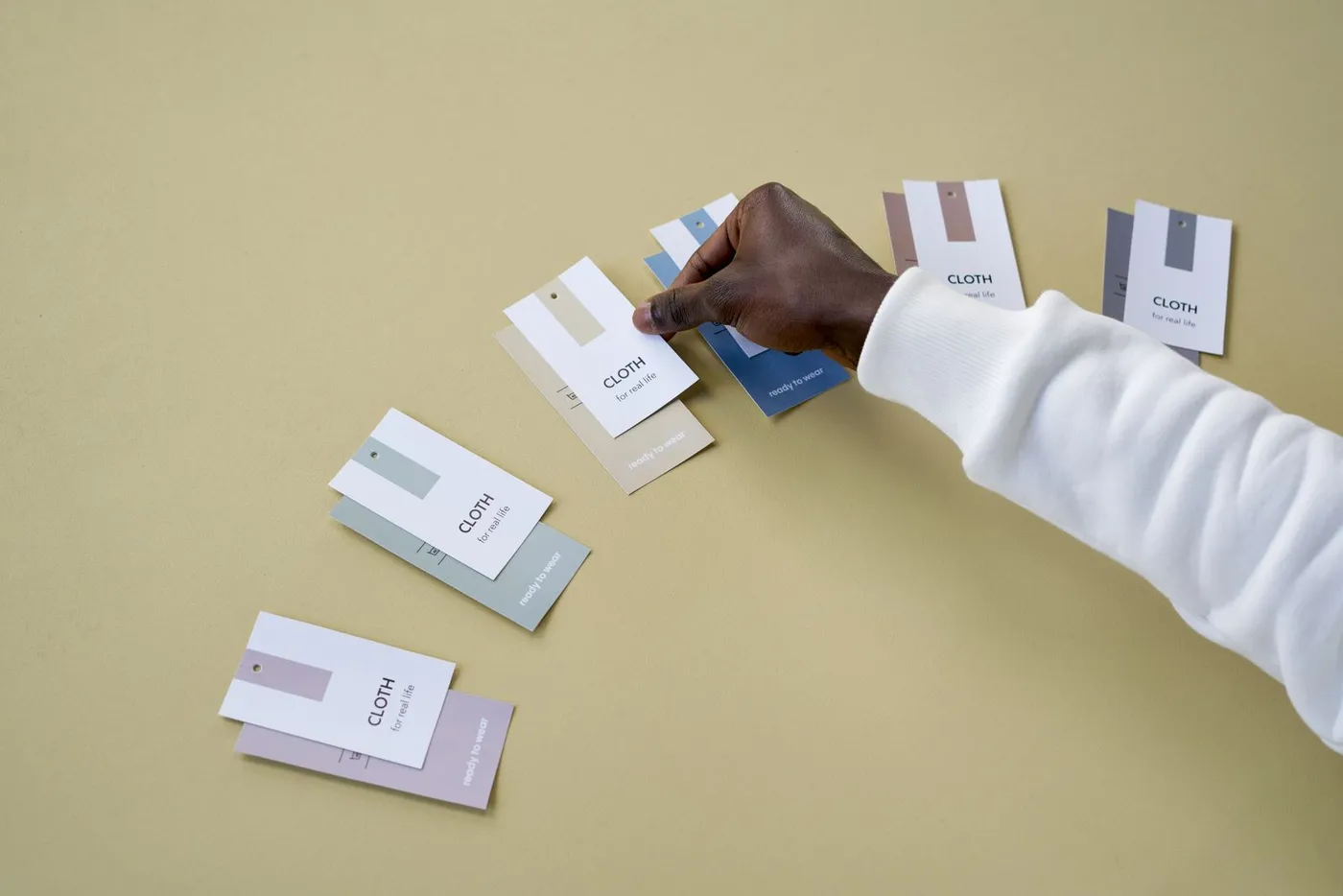 Hands comparing colour sample cards on a table