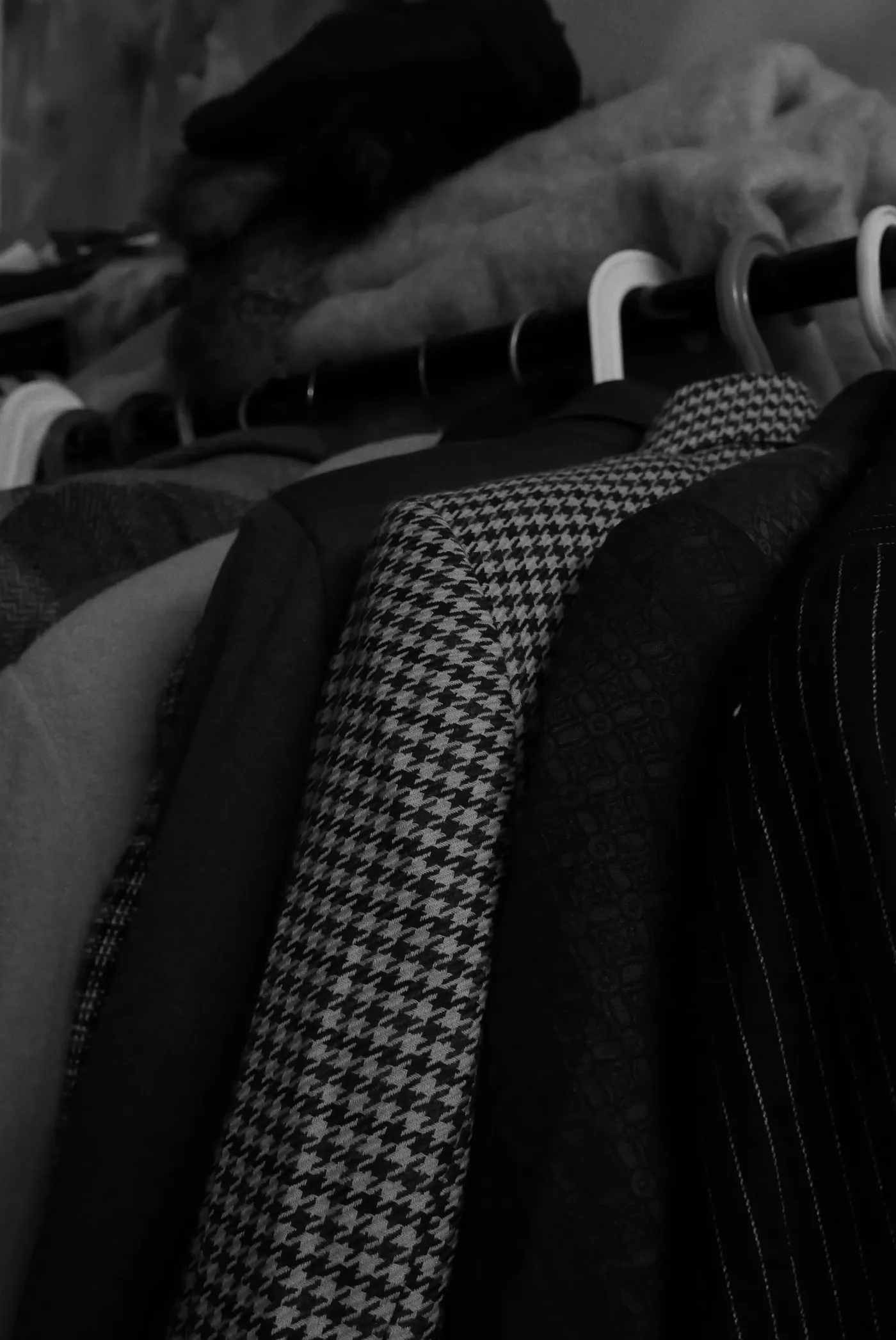 Textured jackets hanging together in a wardrobe