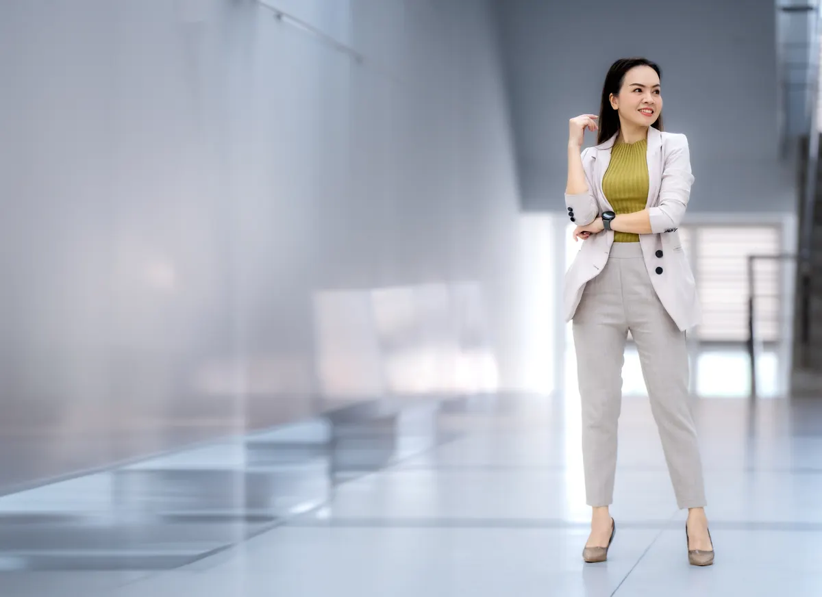 Woman wearing a light blazer and trousers