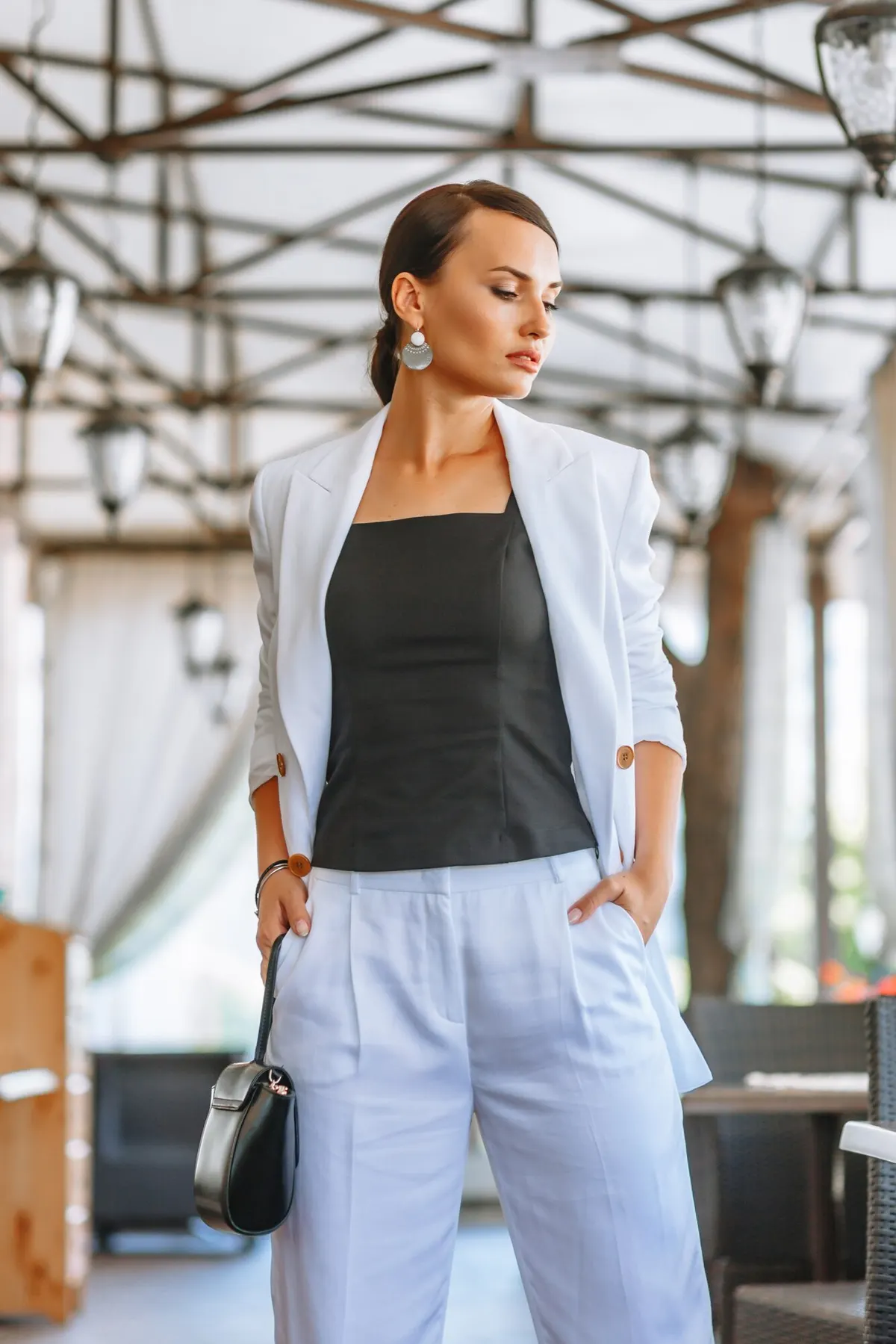 Woman pairing a pale blazer with a black top and jeans