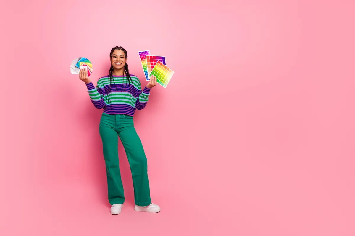 Woman wearing a vivid green outfit against a pink backdrop