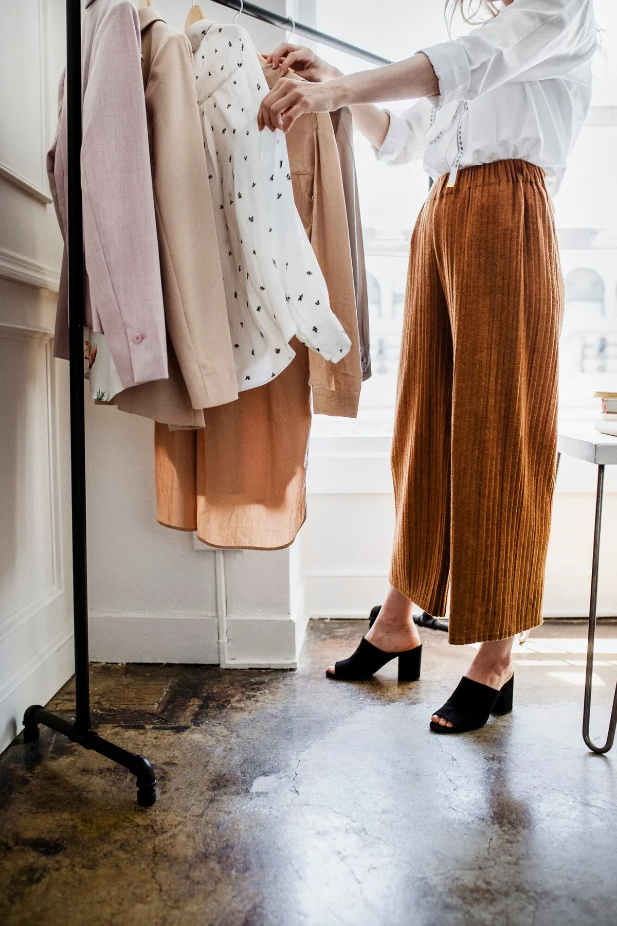 A small wardrobe edit with garments and shoes arranged together