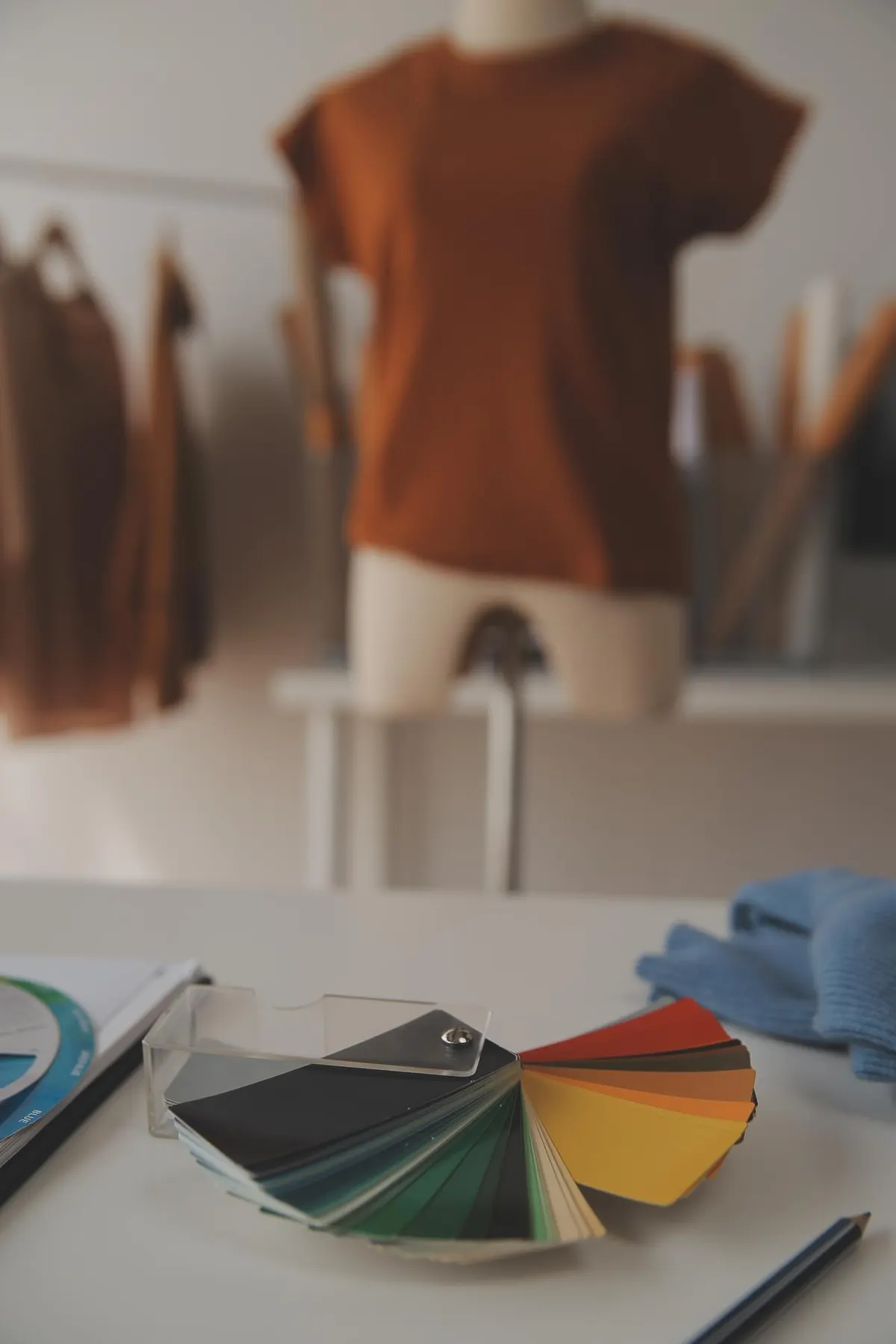 Colour swatches beside a rail of coordinated clothing