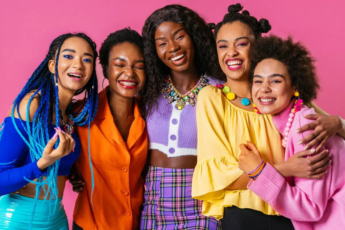 Women wearing vivid blue, orange, yellow and pink tops