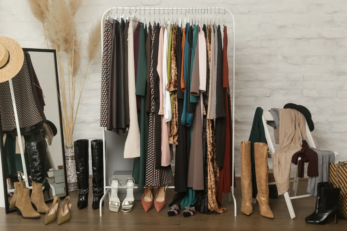 Clothes and accessories arranged on a freestanding wardrobe rail