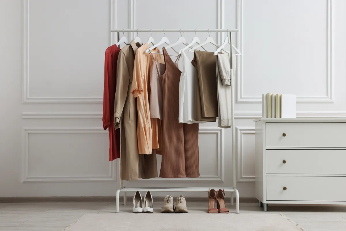 A compact clothing rail with warm neutral layers