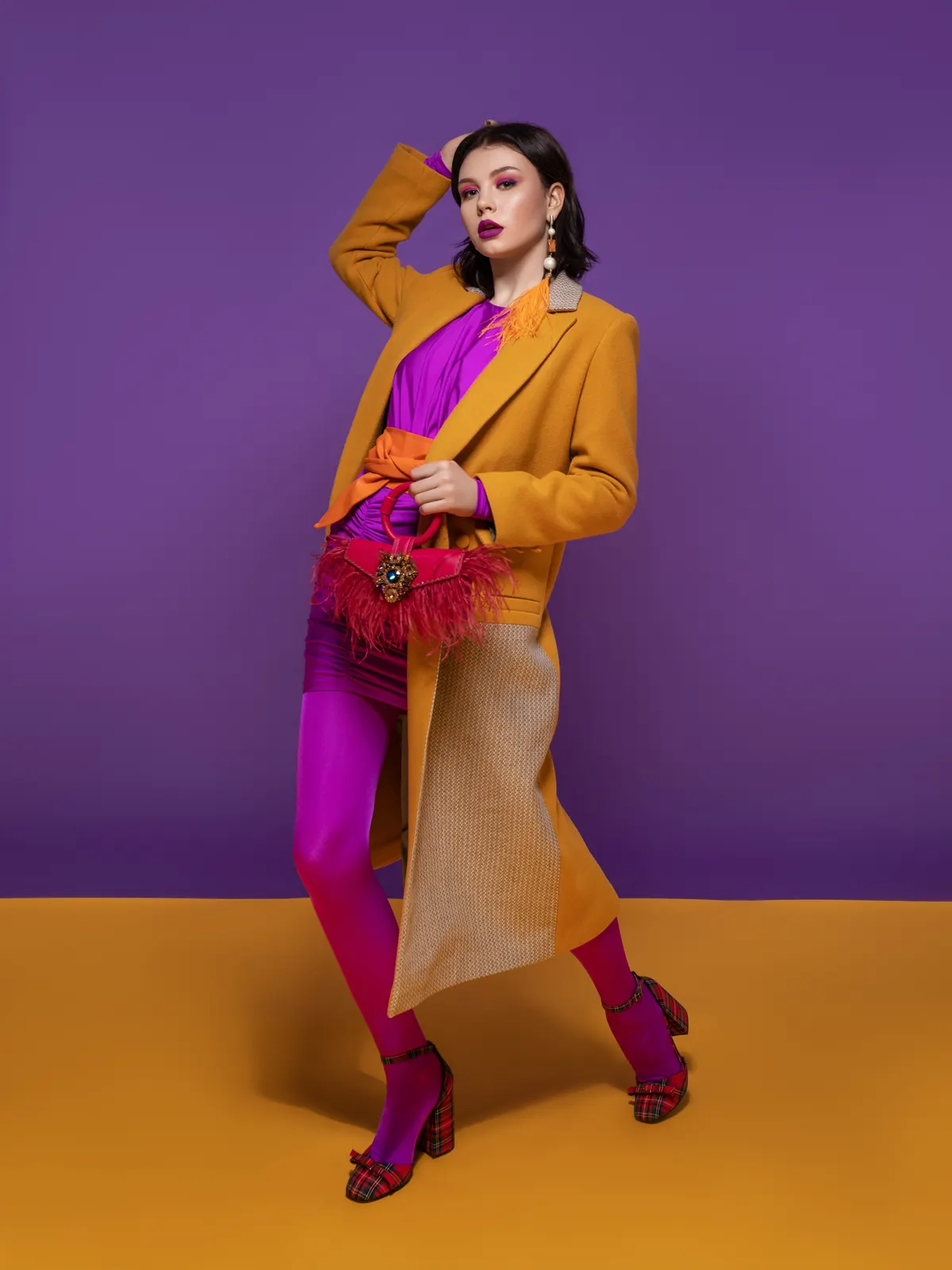 Woman combining a bright pink outfit with a golden layer