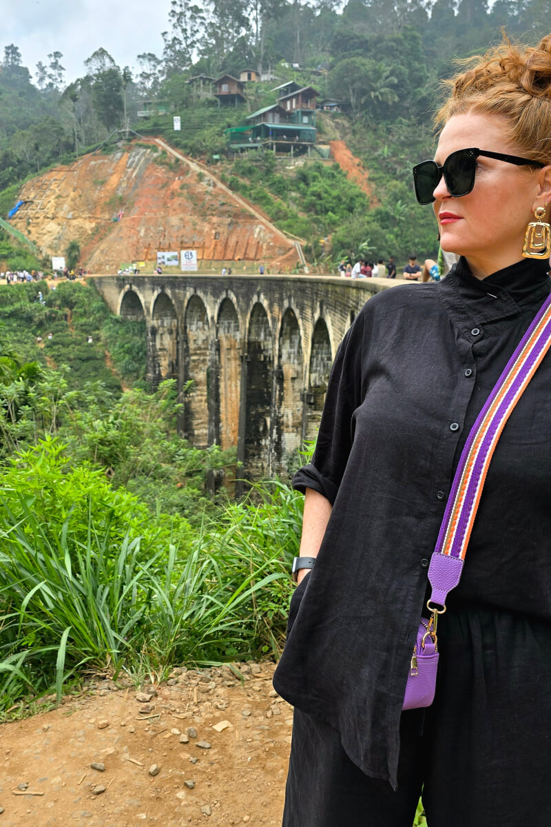 Nyome Polley travelling in a black outfit and colourful accessories